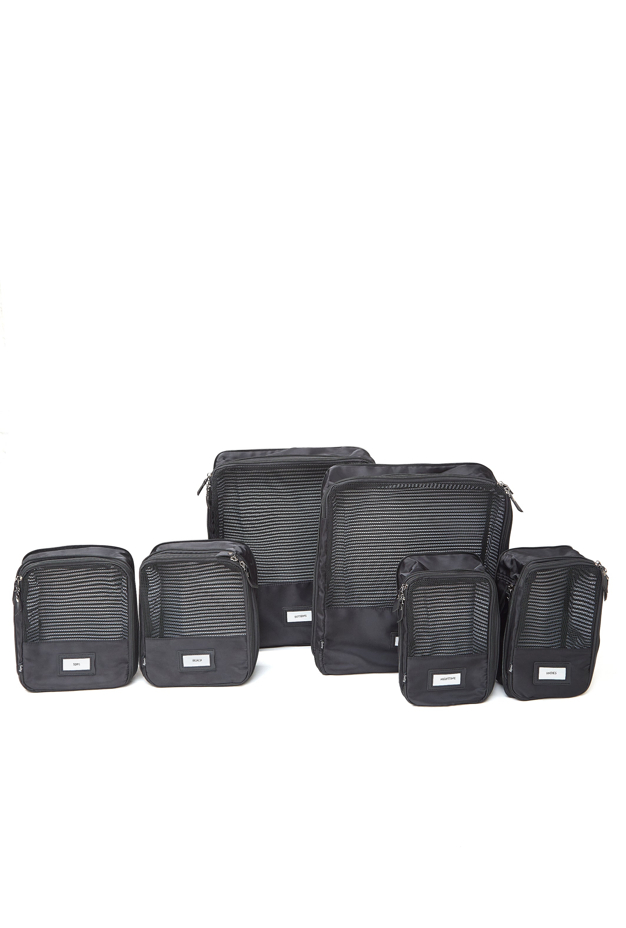 Minimalist black packing cubes stacked for a weekend getaway