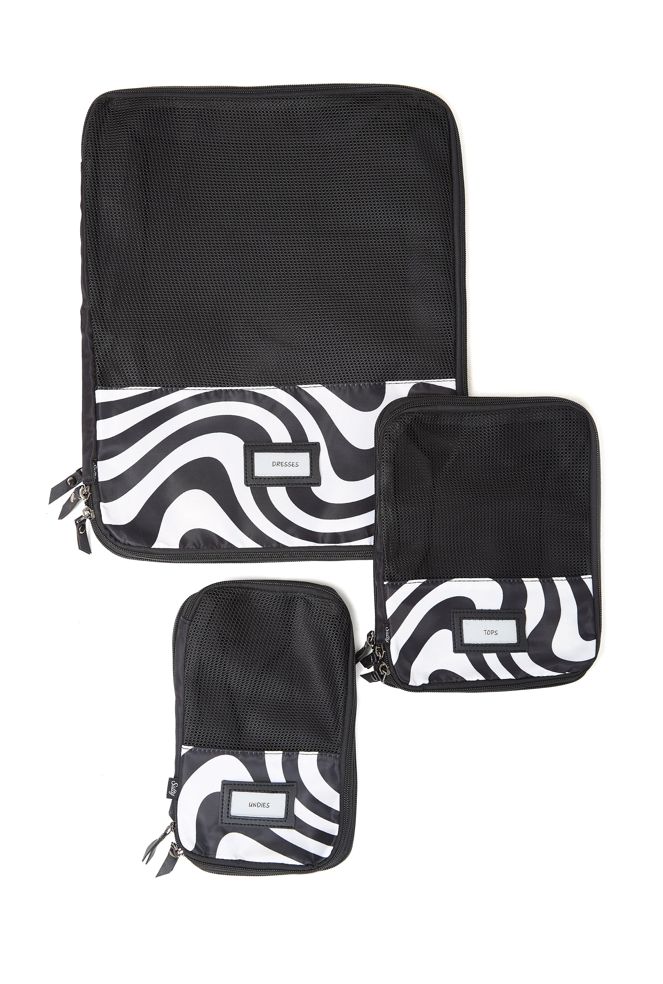 Woman organising luggage using black and white compression cubes